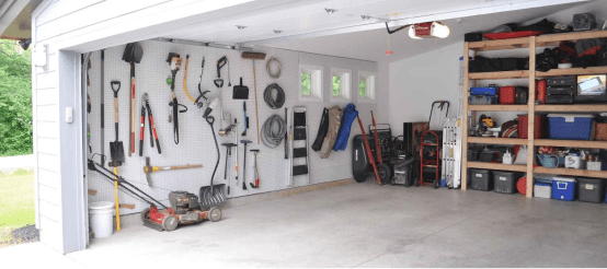 Organized garage interior with tools mounted on pegboard wall and storage shelves