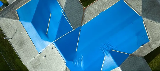 Aerial view of bright blue swimming pool with geometric design and concrete deck