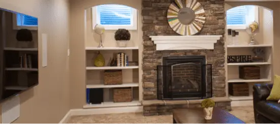 Modern living room with brick fireplace and white built-in shelving units