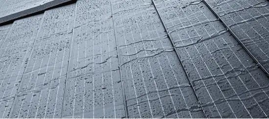 Wet concrete pavement with grid pattern and water droplets after rain