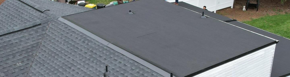 Aerial view of flat roof installation with EPDM rubber membrane on residential building
