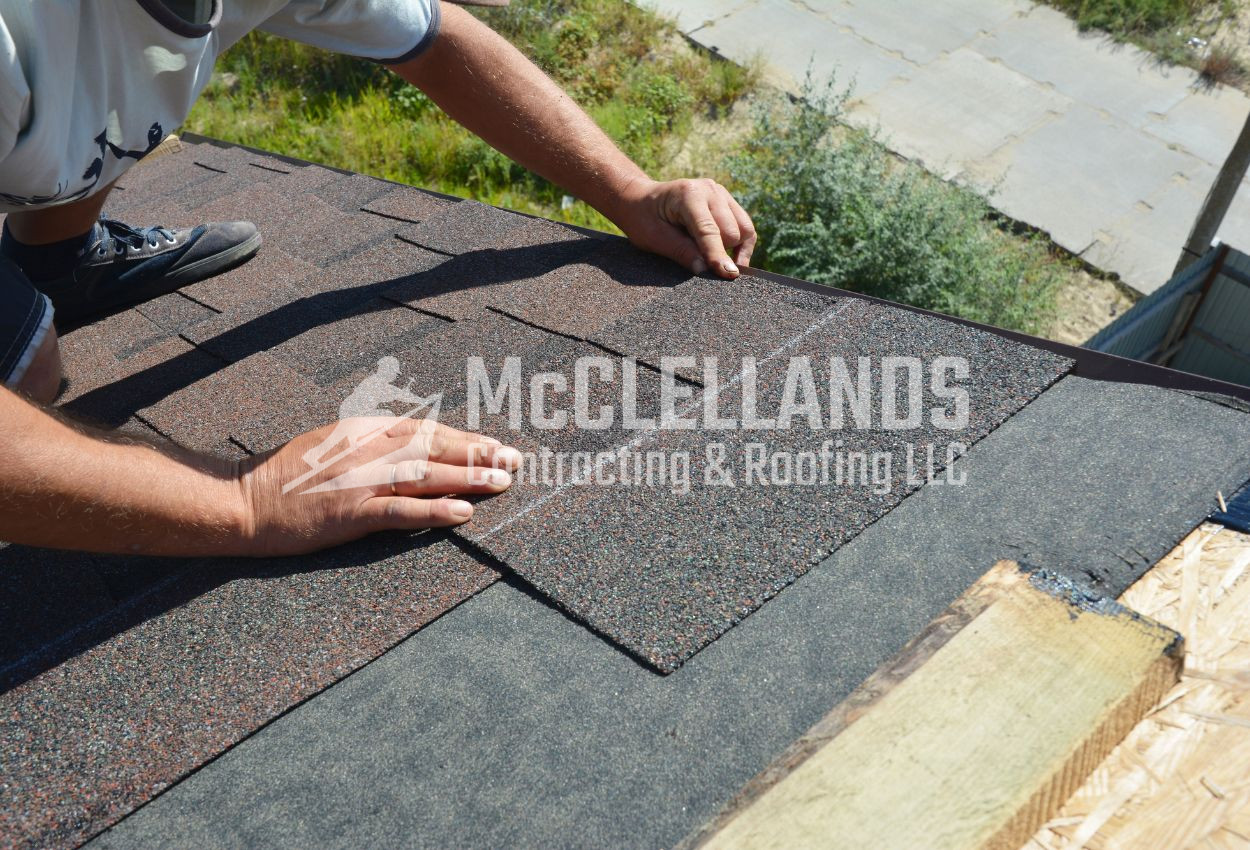 Roofer installing shingles on a roof in daylight, providing roofing service.
