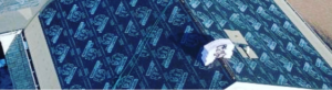 Aerial view of a rooftop with underlayment and equipment.
