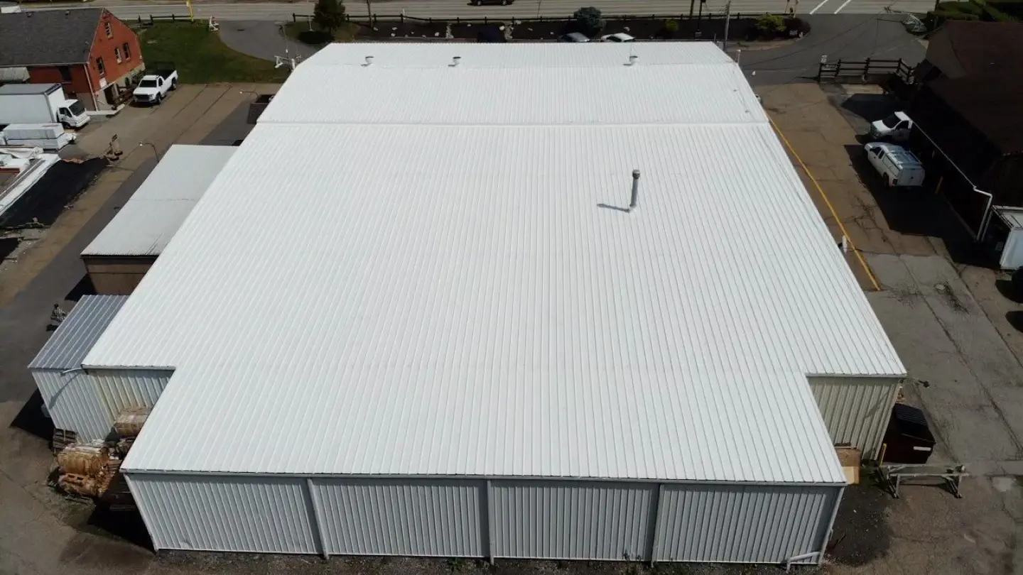 Aerial view of a large white industrial metal roof.
