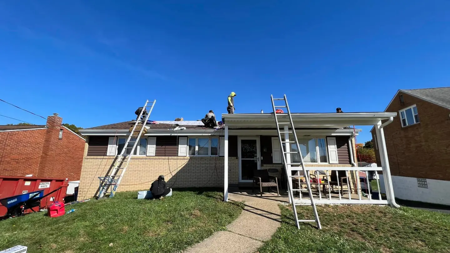 Home roofing project with workers installing new shingles.