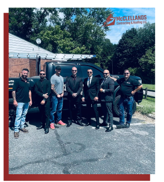 Group of men standing in front of a truck with McClellands logo.
