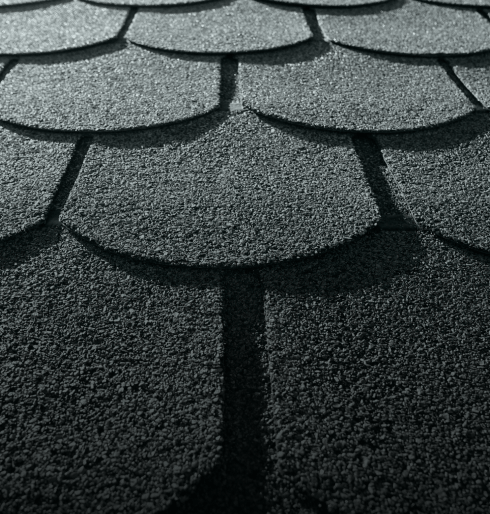 Close-up of textured asphalt roof shingles in a neat pattern